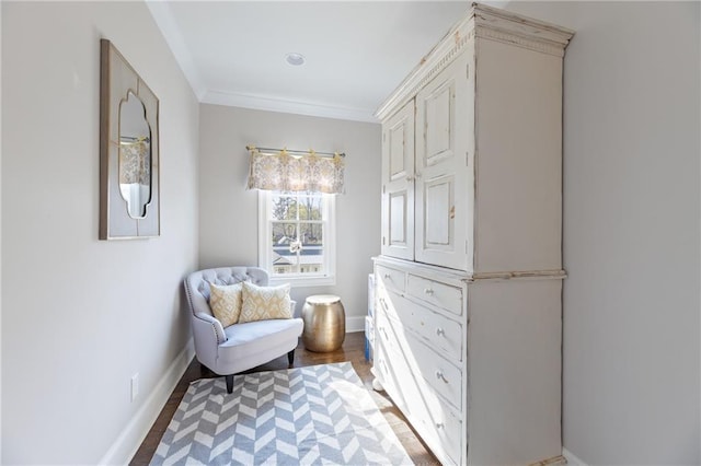 sitting room featuring ornamental molding and dark hardwood / wood-style floors