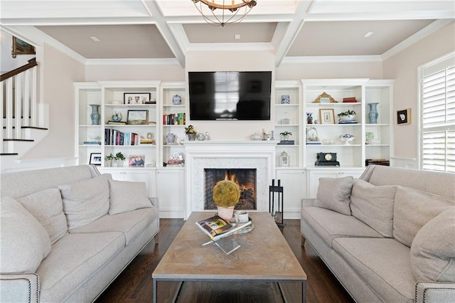 living room with an inviting chandelier, coffered ceiling, dark wood-type flooring, and ornamental molding