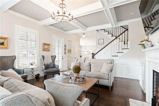 living room featuring plenty of natural light, an inviting chandelier, dark hardwood / wood-style flooring, and coffered ceiling