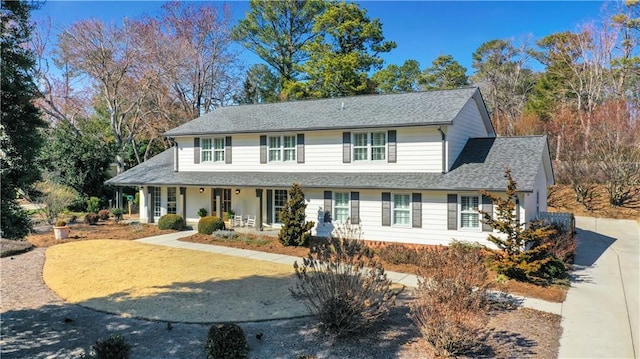 view of front of home with covered porch and roof with shingles