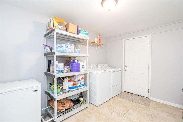 laundry room with laundry area, baseboards, and washer and dryer