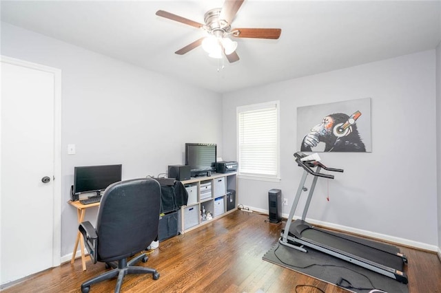 home office with baseboards, ceiling fan, and wood finished floors