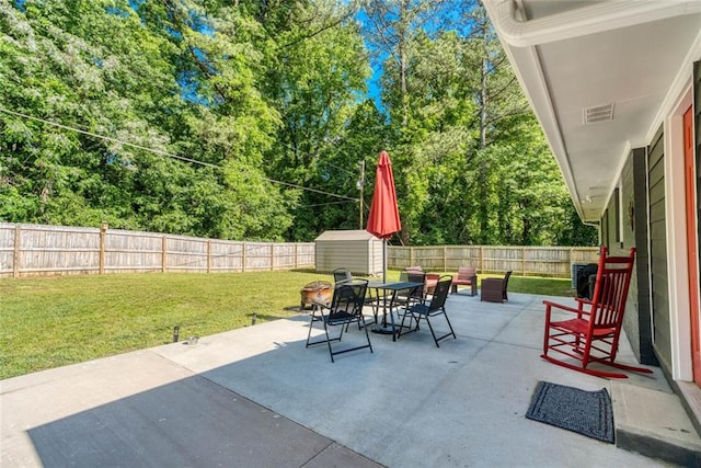 view of patio / terrace with outdoor dining area, visible vents, an outdoor structure, a shed, and a fenced backyard
