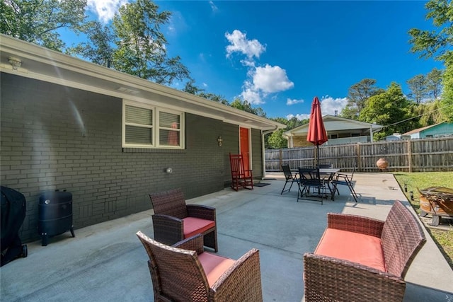 view of patio / terrace featuring fence, outdoor dining space, and grilling area