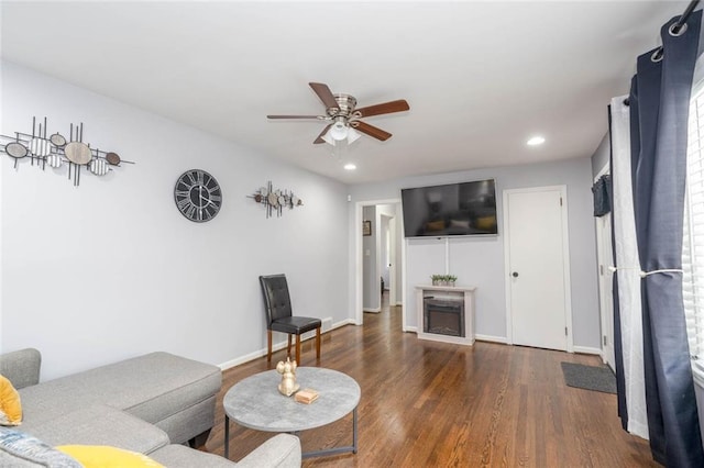 living area featuring recessed lighting, ceiling fan, wood finished floors, and a fireplace