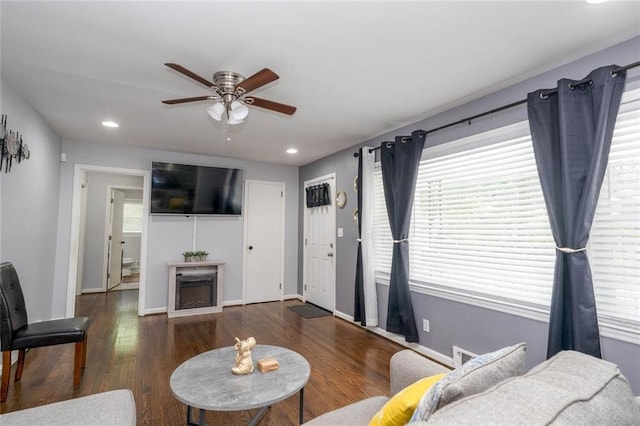 living area with recessed lighting, ceiling fan, wood finished floors, and a fireplace