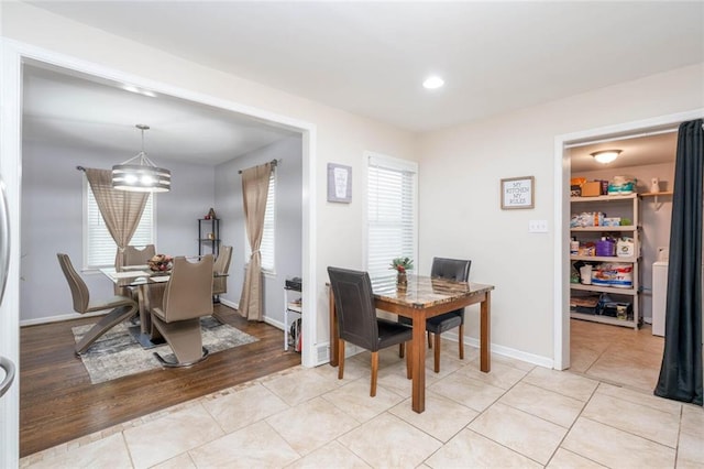 dining space with baseboards, recessed lighting, light tile patterned floors, and a chandelier