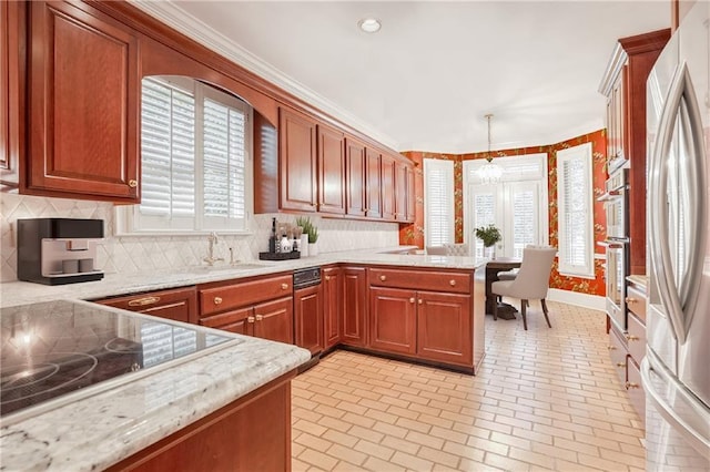 kitchen featuring light stone counters, ornamental molding, kitchen peninsula, pendant lighting, and black electric stovetop