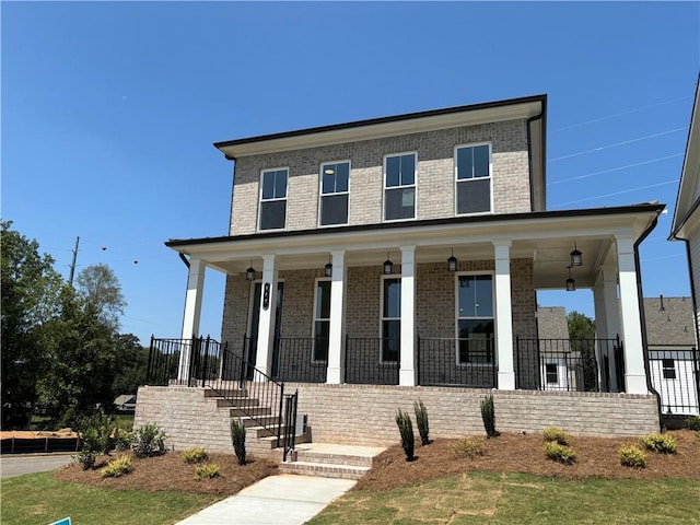 view of front of house featuring a porch and brick siding