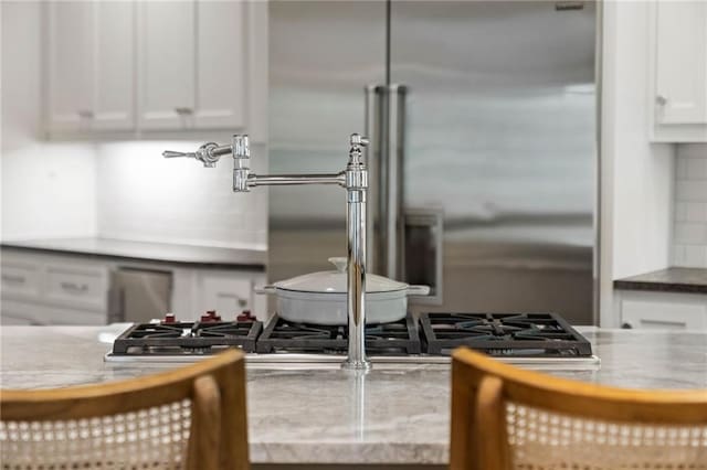 kitchen with built in fridge and white cabinets