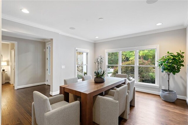 dining space with dark wood-type flooring and ornamental molding