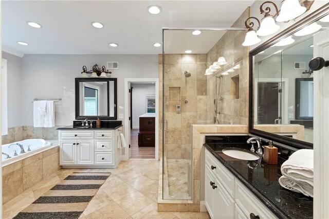 bathroom with tile patterned floors, separate shower and tub, and vanity