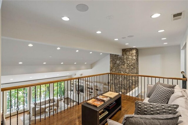 interior space with wood-type flooring and lofted ceiling