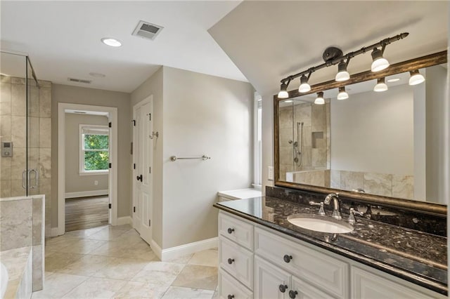 bathroom featuring plus walk in shower, tile patterned flooring, and vanity