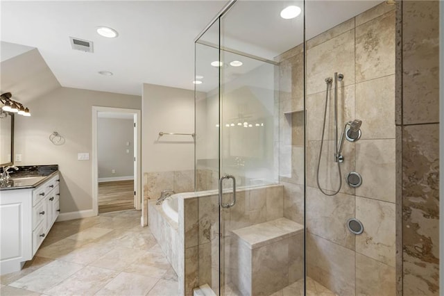 bathroom featuring plus walk in shower, vanity, and wood-type flooring