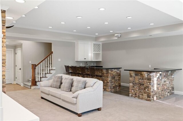 carpeted living room with ornamental molding