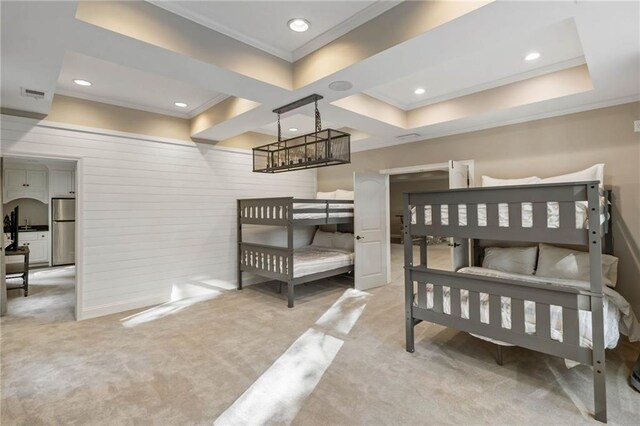 bedroom featuring stainless steel fridge, crown molding, light colored carpet, and a tray ceiling