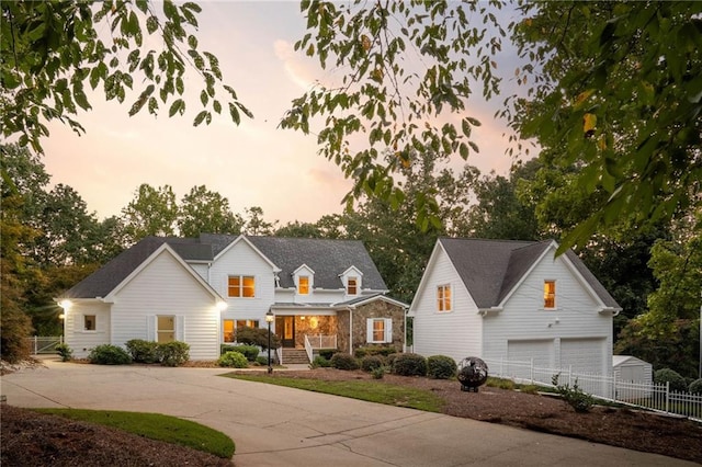 view of front of property featuring an outdoor structure and a garage