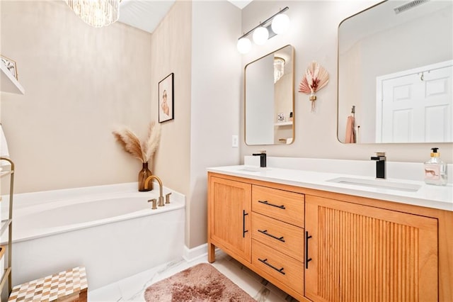 full bathroom with double vanity, a bath, and marble look tile flooring