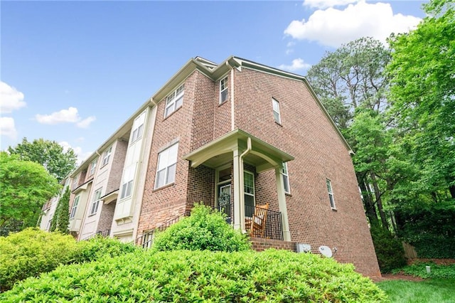 view of side of home with brick siding