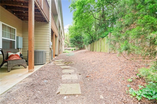 view of yard with cooling unit and fence
