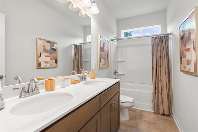 bathroom featuring shower / bath combo with shower curtain, a sink, tile patterned floors, and toilet
