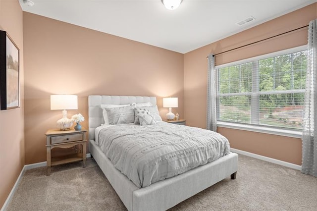 bedroom with carpet floors, baseboards, and visible vents
