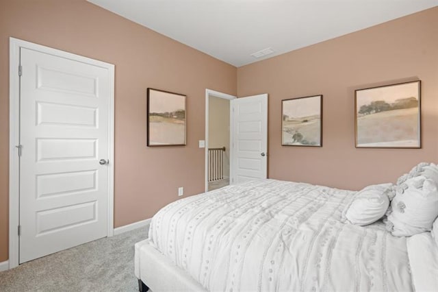 carpeted bedroom featuring baseboards and visible vents