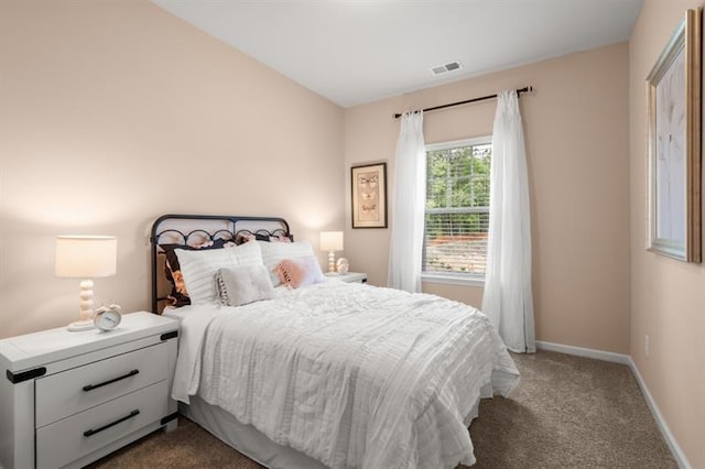 bedroom featuring baseboards, visible vents, and dark carpet