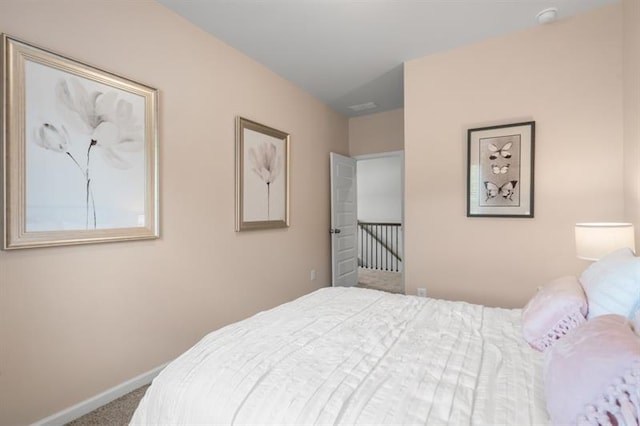 bedroom featuring carpet floors and baseboards