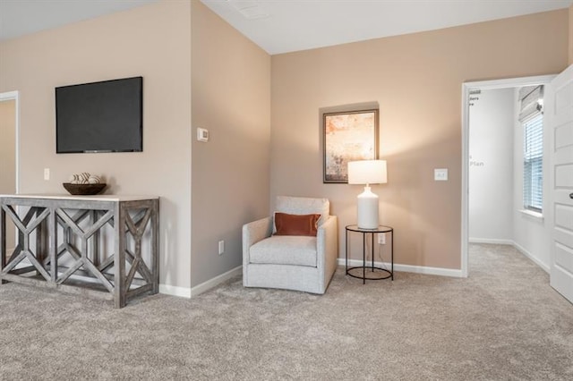 sitting room featuring baseboards and carpet