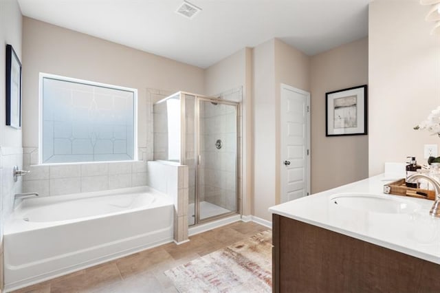 bathroom with visible vents, a garden tub, tile patterned flooring, a shower stall, and a sink