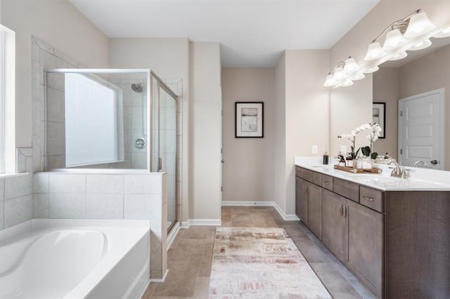 bathroom featuring a garden tub, double vanity, tile patterned flooring, a shower stall, and a sink