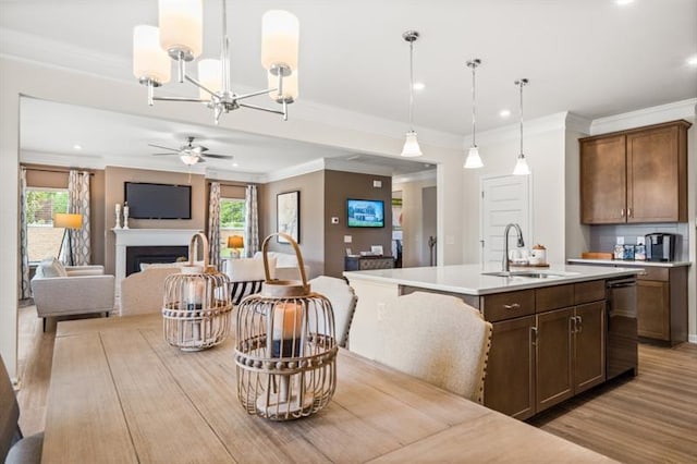dining space with recessed lighting, ornamental molding, ceiling fan with notable chandelier, and light wood-type flooring