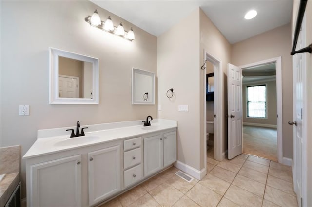 bathroom with tile patterned floors, vanity, and toilet