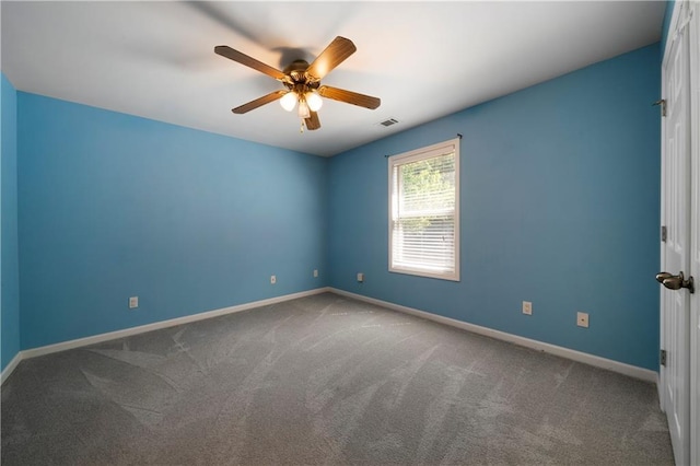 carpeted empty room featuring ceiling fan