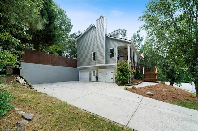 view of side of home with a porch and a garage