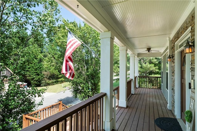 wooden terrace featuring ceiling fan and a porch