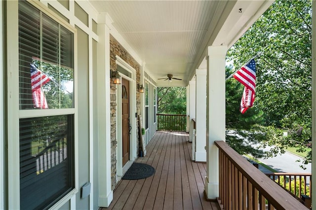 wooden deck with ceiling fan and a porch