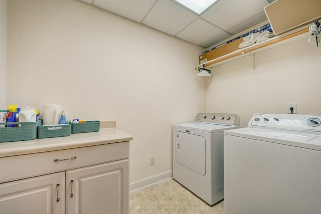 43 Morley Dr, Ellijay, GA 30540 - laundry area with washing machine and clothes dryer, light tile patterned flooring, baseboards, and cabinet space
