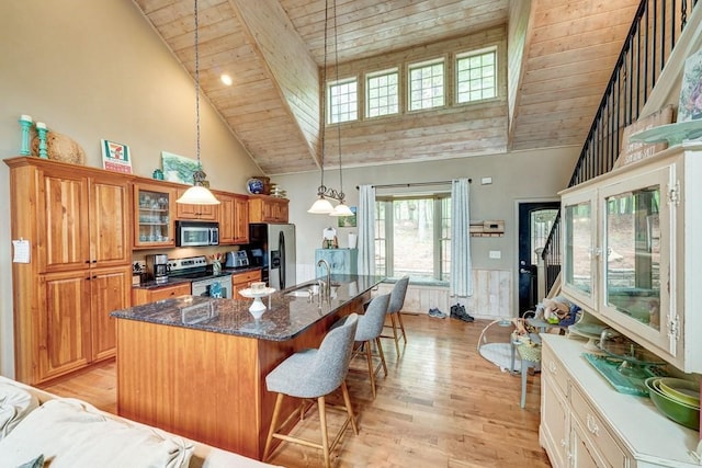 43 Morley Dr, Ellijay, GA 30540 - kitchen featuring stainless steel appliances, high vaulted ceiling, wood ceiling with exposed beams, a breakfast bar area, and a kitchen island with sink