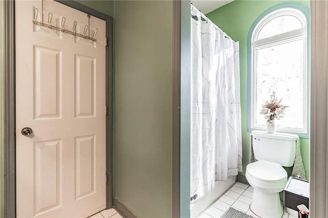 bathroom with tile patterned floors and toilet