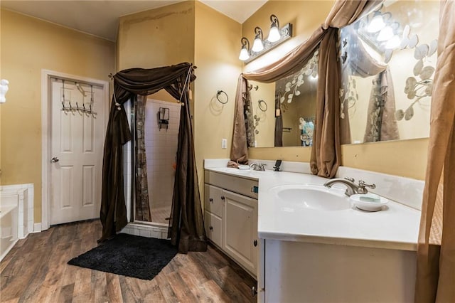 bathroom featuring vanity, wood-type flooring, and shower with separate bathtub