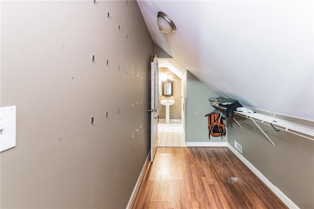 interior space with dark hardwood / wood-style flooring, lofted ceiling, and sink