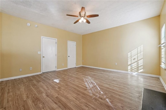 interior space featuring hardwood / wood-style flooring, a textured ceiling, and ceiling fan