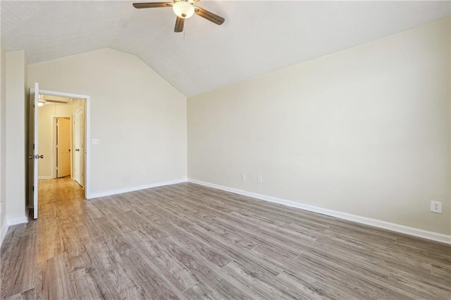 unfurnished room featuring ceiling fan, lofted ceiling, and light hardwood / wood-style flooring