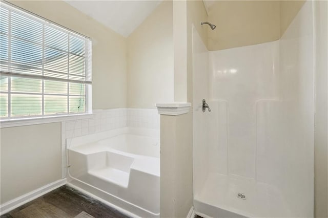 bathroom featuring hardwood / wood-style flooring, lofted ceiling, and independent shower and bath