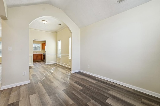 empty room featuring lofted ceiling and hardwood / wood-style floors