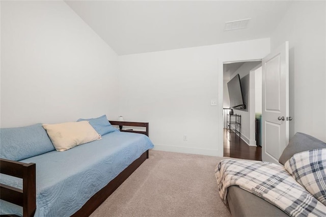 carpeted bedroom featuring lofted ceiling