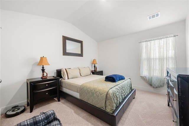 bedroom featuring light carpet and vaulted ceiling